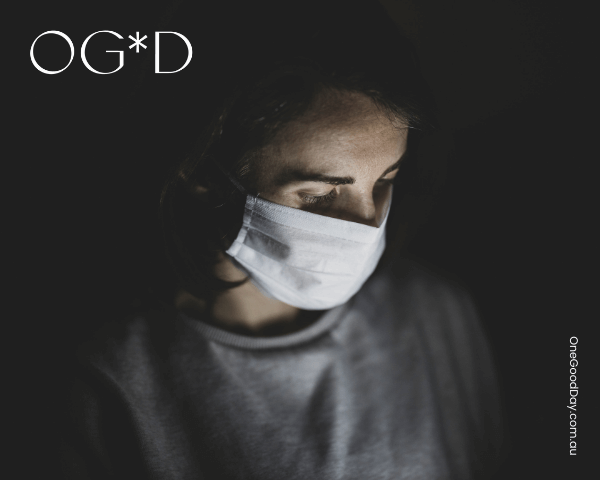 One_Good_Day_Blog_Aiming_for_one_good_day_in_lockdown A solemn looking woman wearing a face mask in a dark space