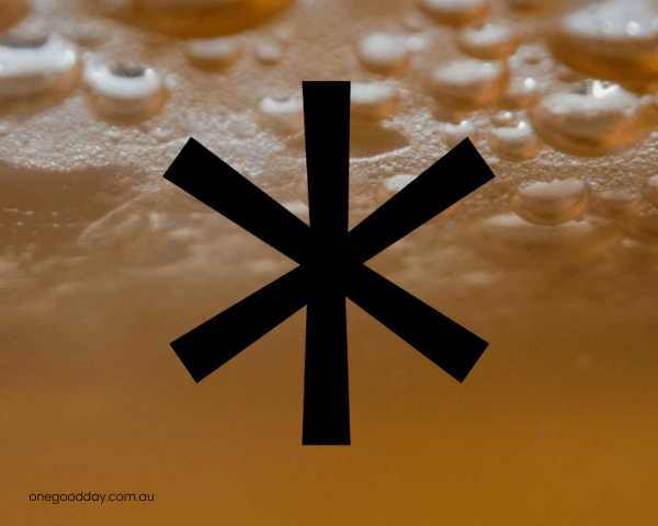 One_Good_Day_Blog_How_Metabolic_Health_Influences_Mental_Health A close up of orange liquid, Kombucha with a large black asterisk in the middle