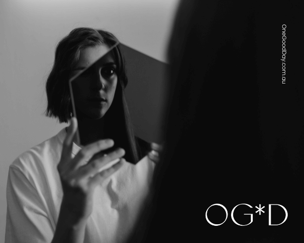 A dark and moody image of a women looking into a mirror.